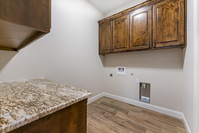 laundry area with cabinets, washer hookup, gas dryer hookup, hookup for an electric dryer, and hardwood / wood-style floors