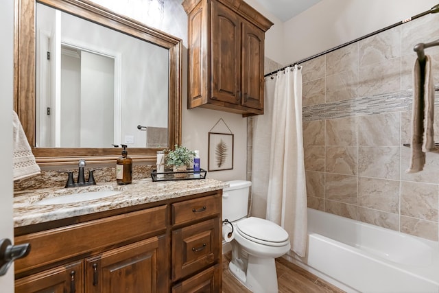 full bathroom featuring shower / tub combo with curtain, vanity, and toilet