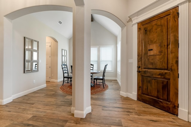 foyer entrance with hardwood / wood-style flooring and lofted ceiling