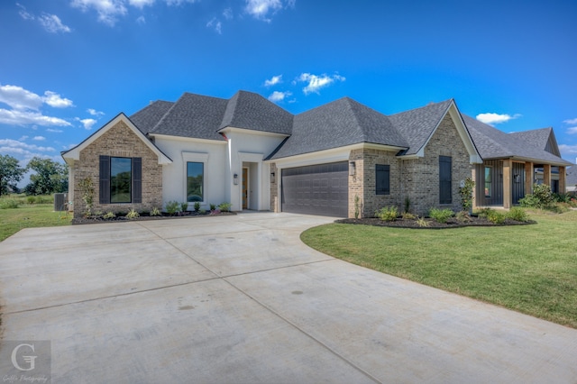 view of front facade featuring a garage and a front lawn