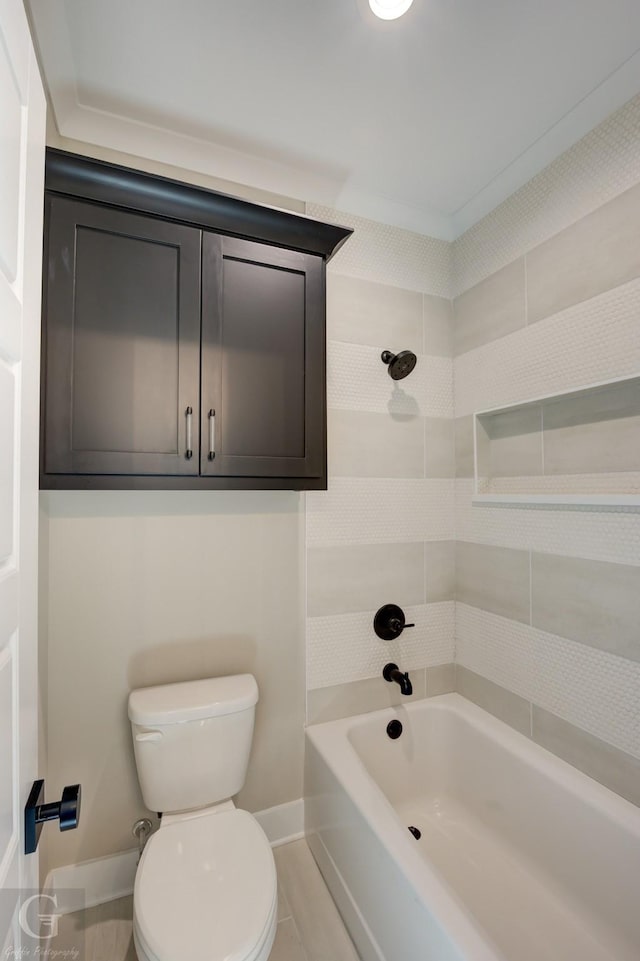 bathroom featuring toilet, ornamental molding, and shower / bath combination