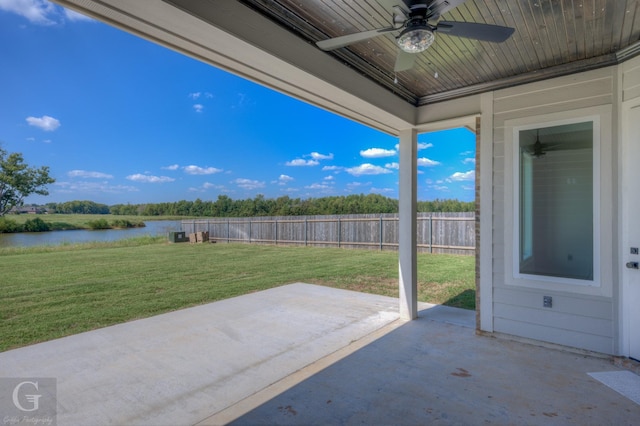 view of patio / terrace with ceiling fan and a water view