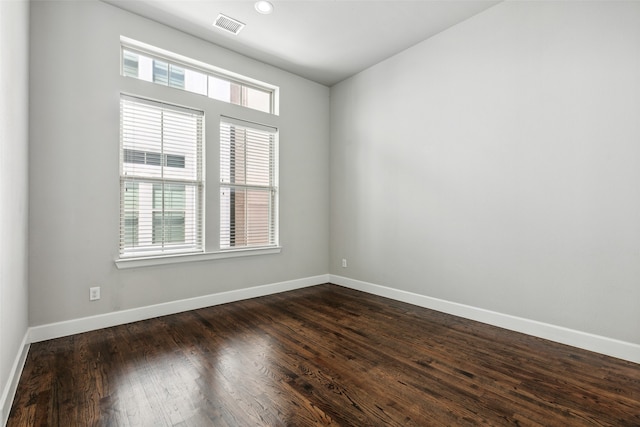 spare room with dark wood-type flooring