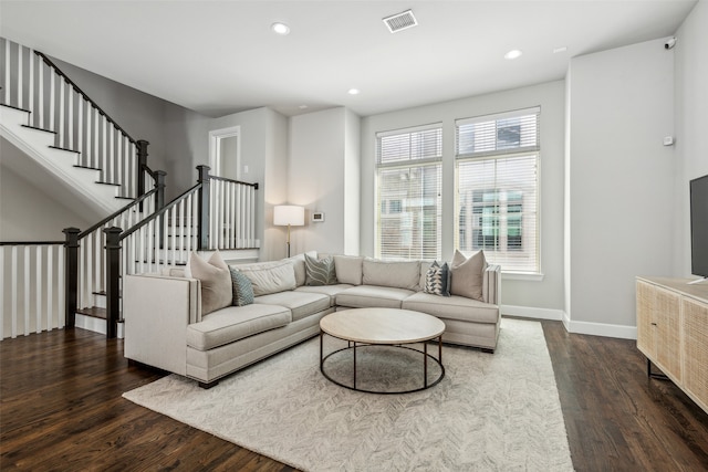 living room with dark hardwood / wood-style flooring