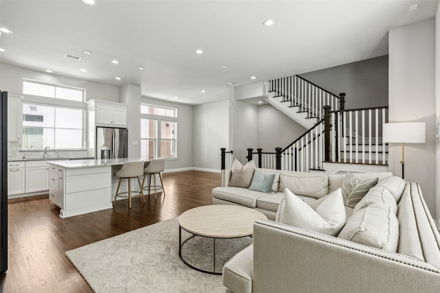 living room with sink and dark hardwood / wood-style floors