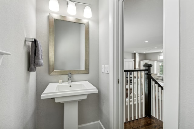 bathroom with wood-type flooring and sink