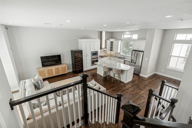 staircase with sink and dark hardwood / wood-style flooring