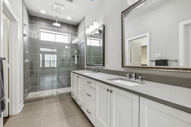 bathroom with dual bowl vanity, an enclosed shower, and tile floors