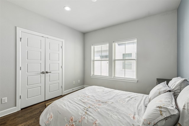 bedroom featuring dark hardwood / wood-style floors and a closet