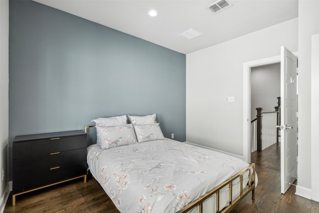 bedroom with dark hardwood / wood-style flooring