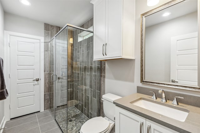 bathroom featuring tile flooring, an enclosed shower, toilet, and vanity