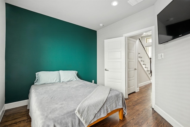 bedroom featuring vaulted ceiling and dark hardwood / wood-style floors