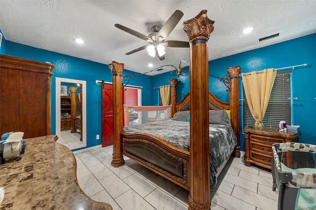 tiled bedroom featuring a textured ceiling, ceiling fan, and connected bathroom