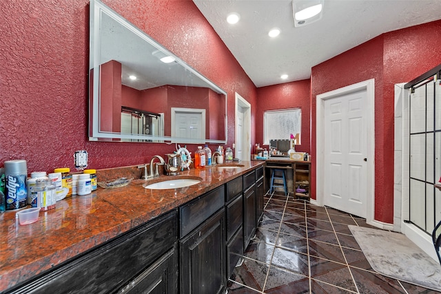 bathroom featuring tile flooring, an enclosed shower, and vanity