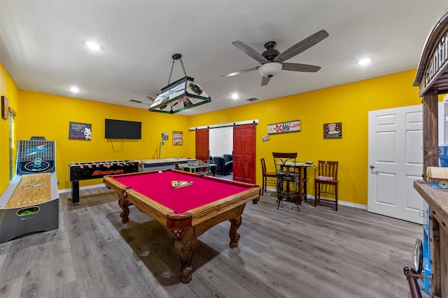 recreation room with a barn door, wood-type flooring, billiards, and ceiling fan