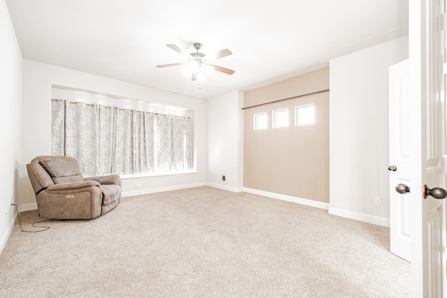 sitting room featuring ceiling fan and carpet flooring