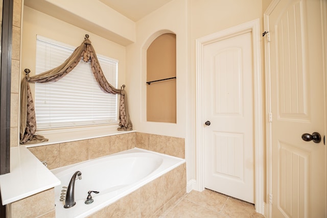 bathroom featuring tile floors and tiled tub