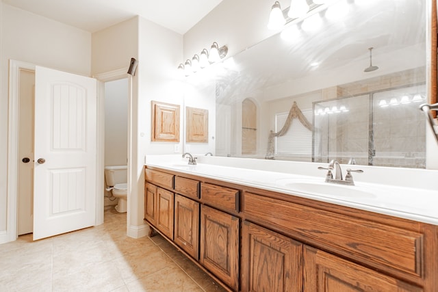 bathroom with tile flooring, oversized vanity, toilet, and double sink