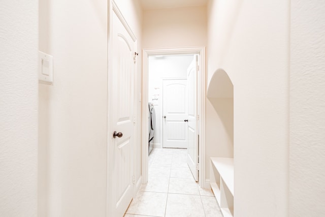 corridor featuring light tile floors