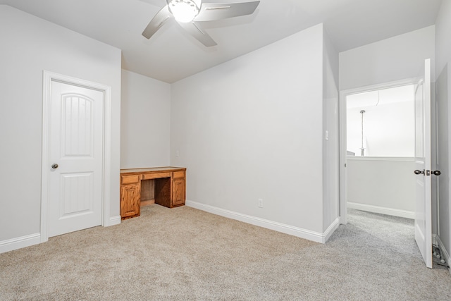 carpeted spare room with ceiling fan