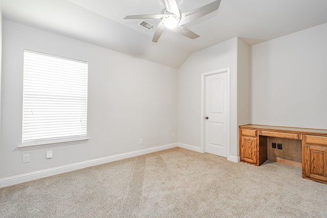 spare room featuring a wealth of natural light, ceiling fan, light colored carpet, and lofted ceiling