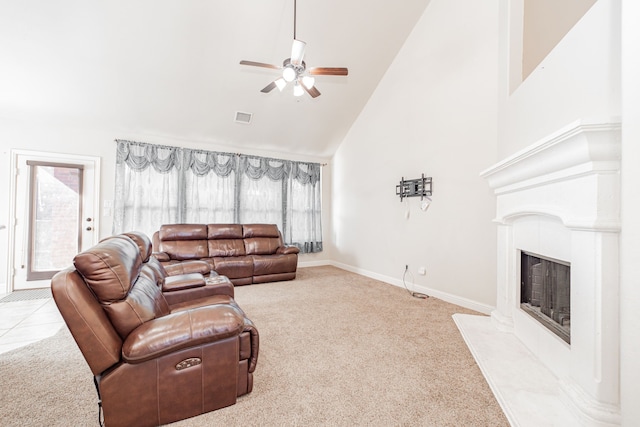 carpeted living room with high vaulted ceiling and ceiling fan