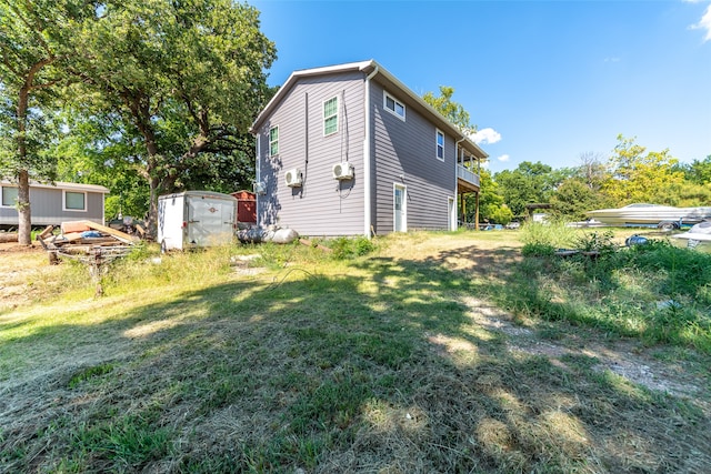 exterior space featuring a lawn and a storage shed