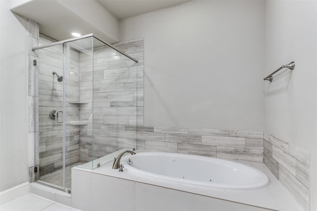 bathroom featuring shower with separate bathtub and tile floors