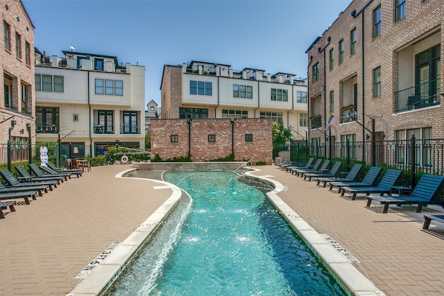 view of swimming pool with pool water feature