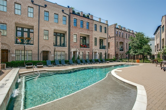 view of swimming pool with pool water feature