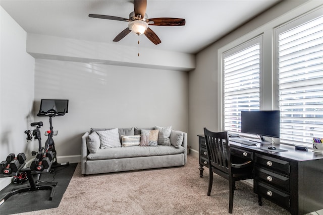 carpeted office space featuring a healthy amount of sunlight and ceiling fan