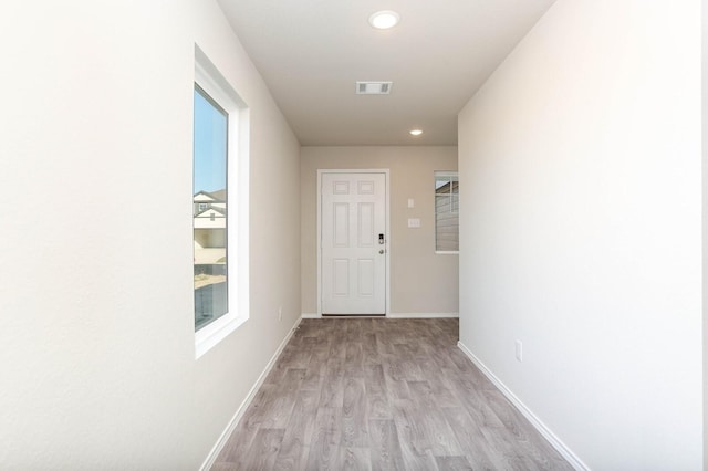 hallway with light hardwood / wood-style flooring