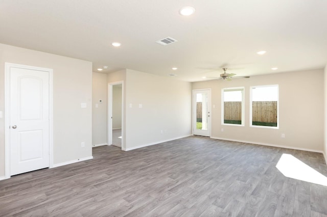 unfurnished living room with ceiling fan and light wood-type flooring