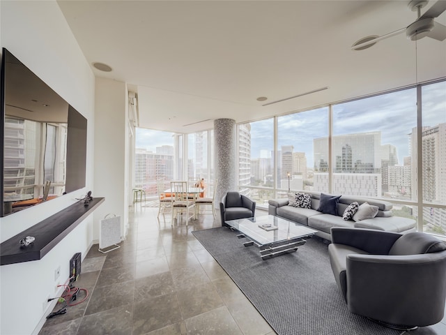 living room featuring a wall of windows and ceiling fan