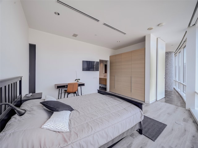 bedroom with light wood-type flooring