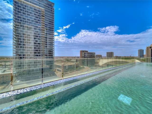 view of pool with a water view