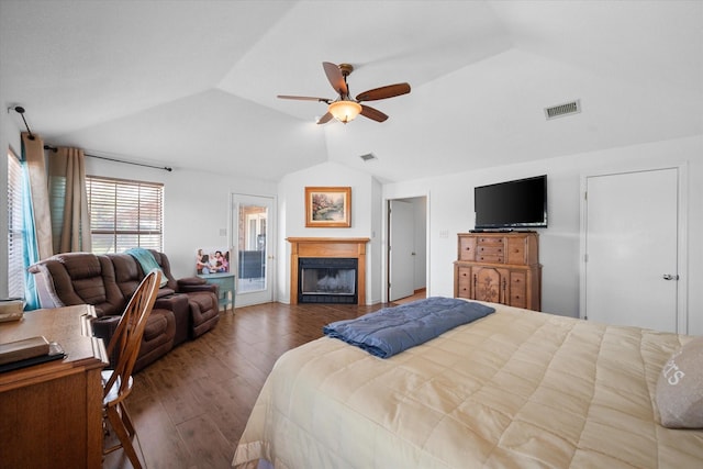 bedroom featuring ceiling fan, dark hardwood / wood-style flooring, and vaulted ceiling