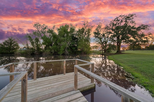 dock area featuring a water view and a yard