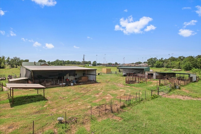 view of yard with a rural view and an outbuilding