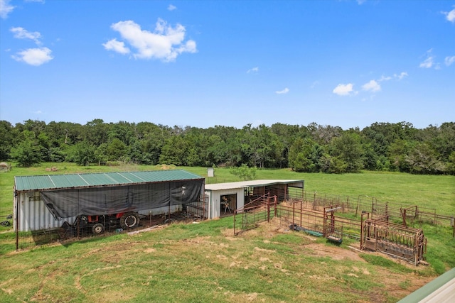 view of yard featuring a rural view and an outbuilding