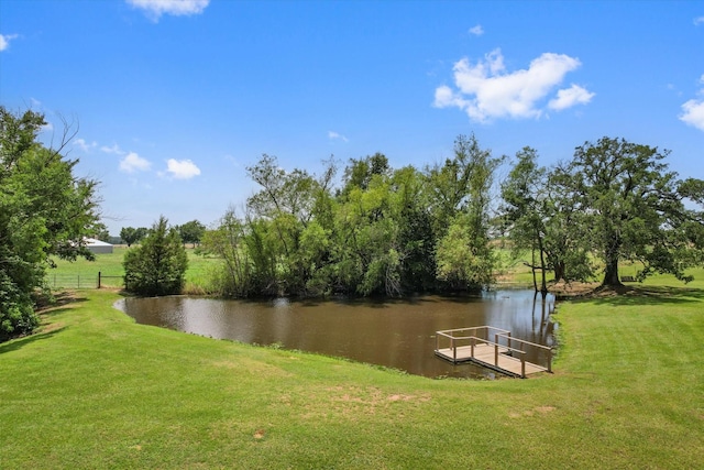 view of community featuring a lawn and a water view