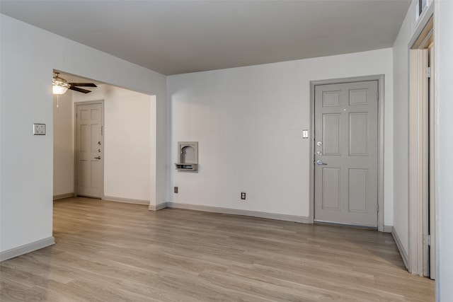 empty room with ceiling fan and light wood-type flooring