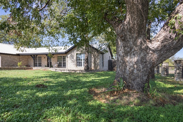 back of house with a lawn