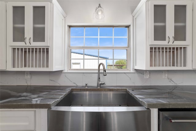 kitchen featuring white cabinets and tasteful backsplash