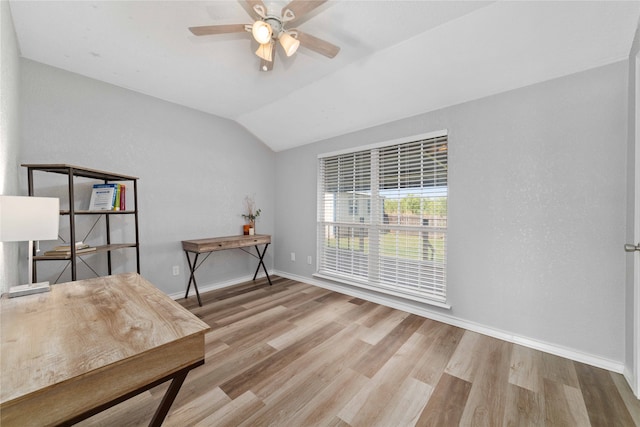 office space with light wood-type flooring, vaulted ceiling, and ceiling fan