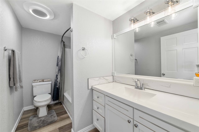 full bathroom featuring hardwood / wood-style floors, vanity, toilet, and shower / tub combo