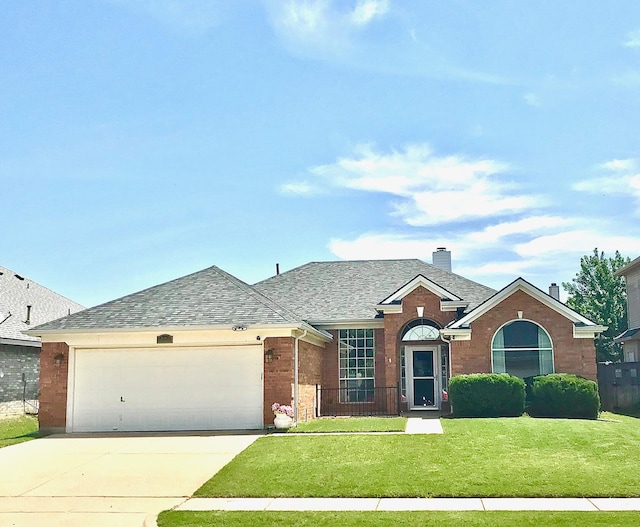 ranch-style home featuring a garage and a front lawn