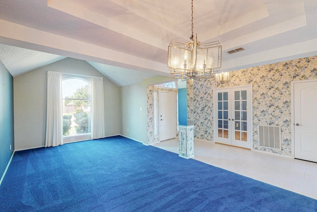 interior space featuring a tray ceiling, a chandelier, french doors, and carpet floors