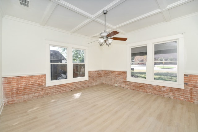 spare room featuring ceiling fan, brick wall, coffered ceiling, and light wood-type flooring