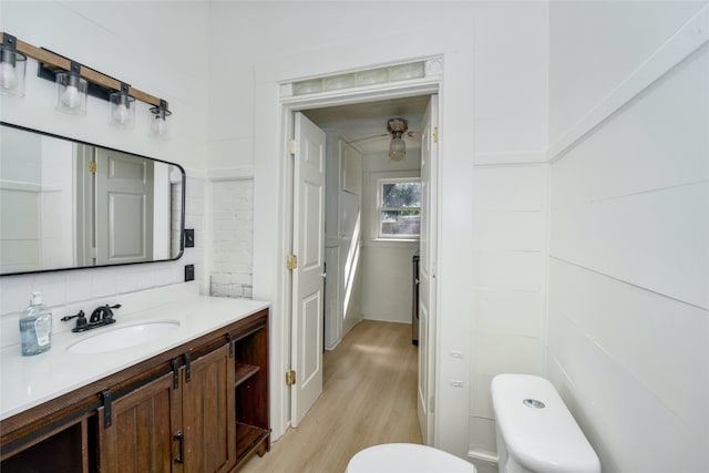 bathroom featuring hardwood / wood-style floors, vanity, and toilet